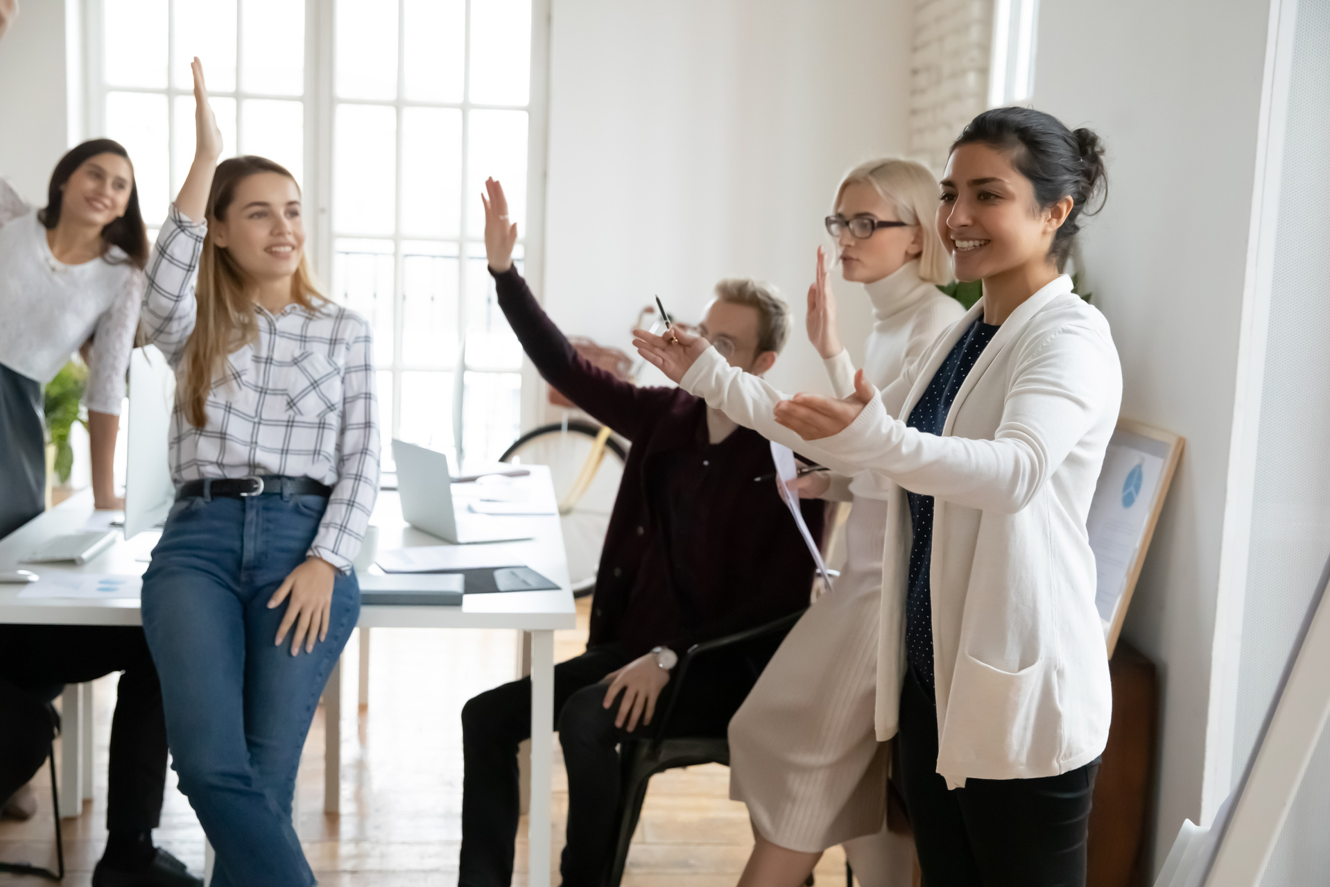 Smiling diverse employees engaged in teambuilding activity